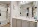 Clean bathroom featuring a large mirror, white cabinets, and shower-tub combo at 7246 Gladstone Cir, Lithonia, GA 30038