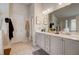 Bright bathroom featuring double sinks, generous vanity space, walk-in closet, and separate shower at 7246 Gladstone Cir, Lithonia, GA 30038