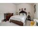 Bedroom with dark wood furniture, soft carpet, and natural lighting at 7246 Gladstone Cir, Lithonia, GA 30038