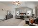 Bright bedroom with neutral carpet, vaulted ceilings, ceiling fan, and sitting area at 7246 Gladstone Cir, Lithonia, GA 30038