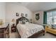 Cozy bedroom with decorative pillows and a yellow sofa near the window at 7246 Gladstone Cir, Lithonia, GA 30038