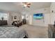 Generous bedroom with neutral carpet, ceiling fan, a leather couch, and a wall-mounted TV at 7246 Gladstone Cir, Lithonia, GA 30038
