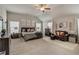 Spacious bedroom featuring neutral carpet, vaulted ceilings, ceiling fan, and sitting area at 7246 Gladstone Cir, Lithonia, GA 30038