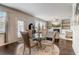Open concept dining area features a glass table and view into the living room at 7246 Gladstone Cir, Lithonia, GA 30038