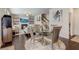Stylish dining area connected to living room, featuring a glass table and modern lighting at 7246 Gladstone Cir, Lithonia, GA 30038