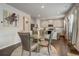 Open dining area features a glass table and view into the bright kitchen at 7246 Gladstone Cir, Lithonia, GA 30038