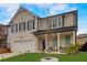 Charming two-story brick home with attached garage and a well-manicured front yard at 7246 Gladstone Cir, Lithonia, GA 30038