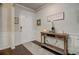 Bright entryway featuring hardwood floors, console table, and decorative wall molding at 7246 Gladstone Cir, Lithonia, GA 30038