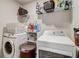 Bright laundry room with a white washer and dryer and ample shelving space for storage solutions at 7246 Gladstone Cir, Lithonia, GA 30038