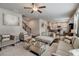 Open concept living room with hardwood floors, neutral furniture, and seamless flow to dining area at 7246 Gladstone Cir, Lithonia, GA 30038