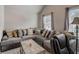 Spacious living room with a plush gray sofa, decorative pillows, and a lamp at 7246 Gladstone Cir, Lithonia, GA 30038