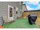 Cozy back patio with outdoor seating, a grill, and well-maintained lawn at 7246 Gladstone Cir, Lithonia, GA 30038