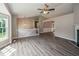 Open-concept living area with hardwood floors, a ceiling fan, and a fireplace at 75 Willow Bend Nw Dr, Cartersville, GA 30121
