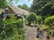 Side yard shows brick details, plants, and an outdoor seating area at 1526 Snapfinger Rd, Decatur, GA 30032
