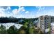 Apartment building with balconies overlooking a lush green space with a city skyline in the background at 675 Drewry Ne St # 205, Atlanta, GA 30306