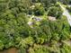Panoramic aerial view highlights this home's serene, wooded setting near a river and convenient access to the main road at 1535 Pathfinder Sw Way, Lilburn, GA 30047