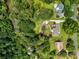 Expansive aerial view of a charming home nestled on a large lot bordered by lush trees and a serene stream at 1535 Pathfinder Sw Way, Lilburn, GA 30047