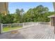 Spacious back deck with white railings overlooking a lush, wooded backyard at 1535 Pathfinder Sw Way, Lilburn, GA 30047