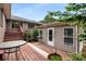 Backyard view featuring a cozy detached living area and a wooden deck at 1535 Pathfinder Sw Way, Lilburn, GA 30047