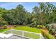 Overlooking the expansive backyard with manicured lawn and mature trees from the back deck at 1535 Pathfinder Sw Way, Lilburn, GA 30047