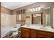Main bathroom featuring a double vanity with stylish mirrors, a combination tub and shower, and neutral decor at 1535 Pathfinder Sw Way, Lilburn, GA 30047