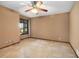 Bedroom featuring tile flooring, a ceiling fan, and a large window with natural light at 1535 Pathfinder Sw Way, Lilburn, GA 30047