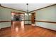 Bright dining room with hardwood floors, wainscoting and decorative light fixture at 1535 Pathfinder Sw Way, Lilburn, GA 30047