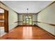 Inviting dining room featuring hardwood floors, wainscoting and elegant chandelier at 1535 Pathfinder Sw Way, Lilburn, GA 30047