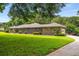 Brick and stone home with manicured lawn, long driveway and mature trees at 1535 Pathfinder Sw Way, Lilburn, GA 30047