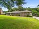 Lovely exterior view of a stone and brick home, complimented by a large lawn and an attached side entry garage at 1535 Pathfinder Sw Way, Lilburn, GA 30047