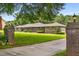 Beautiful brick and stone home with lush green lawn and mature trees at 1535 Pathfinder Sw Way, Lilburn, GA 30047