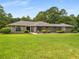Attractive brick and stone home with a well-maintained lawn and mature trees at 1535 Pathfinder Sw Way, Lilburn, GA 30047