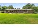 Charming brick and stone home with a well-manicured lawn and mature trees at 1535 Pathfinder Sw Way, Lilburn, GA 30047