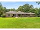 Charming one-story home featuring a brick and stone facade, manicured landscaping, and a lush green lawn at 1535 Pathfinder Sw Way, Lilburn, GA 30047