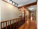 Upstairs hallway featuring hardwood floors, decorative trim and access to multiple rooms at 1535 Pathfinder Sw Way, Lilburn, GA 30047