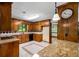 View of kitchen with wood cabinetry, granite countertops, and updated appliances at 1535 Pathfinder Sw Way, Lilburn, GA 30047