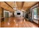 Spacious living room featuring hardwood floors, stone fireplace and beamed ceiling at 1535 Pathfinder Sw Way, Lilburn, GA 30047