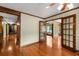 Open living room space featuring hardwood floors, French doors, and wood trim at 1535 Pathfinder Sw Way, Lilburn, GA 30047