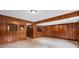 Living room showcasing wood-paneled walls, tile floors, and built-in features for a cozy ambiance at 1535 Pathfinder Sw Way, Lilburn, GA 30047