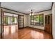 Living room with hardwood floors, French doors, and views of the outdoors at 1535 Pathfinder Sw Way, Lilburn, GA 30047