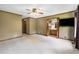 Spacious main bedroom with neutral carpet, ceiling fan, windows with views, and access to the en suite bathroom at 1535 Pathfinder Sw Way, Lilburn, GA 30047