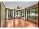 Bright sunroom with hardwood floors and large windows offering serene views at 1535 Pathfinder Sw Way, Lilburn, GA 30047