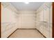 Spacious walk-in closet with extensive shelving and storage for optimal organization and convenience at 1535 Pathfinder Sw Way, Lilburn, GA 30047