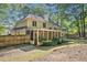 Large backyard featuring a spacious screened-in porch with lush, green backdrop at 2130 Hampton Se Trl, Conyers, GA 30013