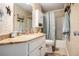 Cozy bathroom features granite countertops, wallpaper and shower with blue curtain at 2130 Hampton Se Trl, Conyers, GA 30013