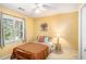 Bedroom with neutral colors, a window with natural light, and wooden furniture at 2130 Hampton Se Trl, Conyers, GA 30013