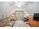 Bright attic bedroom with sitting area and desk space, perfect for relaxation and productivity at 2130 Hampton Se Trl, Conyers, GA 30013