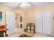 Bedroom featuring closet storage, with neutral colors, and an entry door at 2130 Hampton Se Trl, Conyers, GA 30013