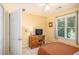 Bedroom with natural light, wooden furniture, and neutral colors at 2130 Hampton Se Trl, Conyers, GA 30013