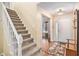 Welcoming foyer with hardwood floors, staircase, and coat rack, leading into a bright and open living space at 2130 Hampton Se Trl, Conyers, GA 30013